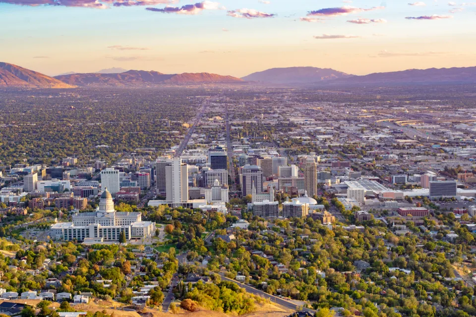 Aerial view of Salt Lake City, Utah with capitol dome in foreground again sunset sky.
